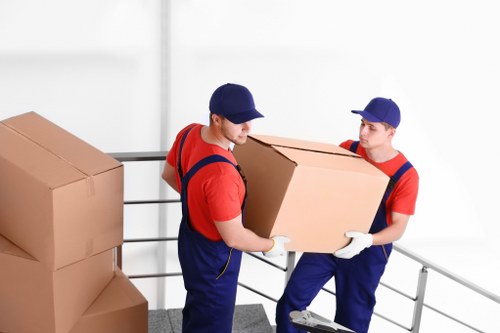 Local moving team transporting boxes and household items in Hammersmith